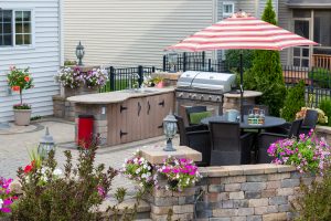 Upscale Outdoor Patio With Kitchen Area And Comfortable Wicker F